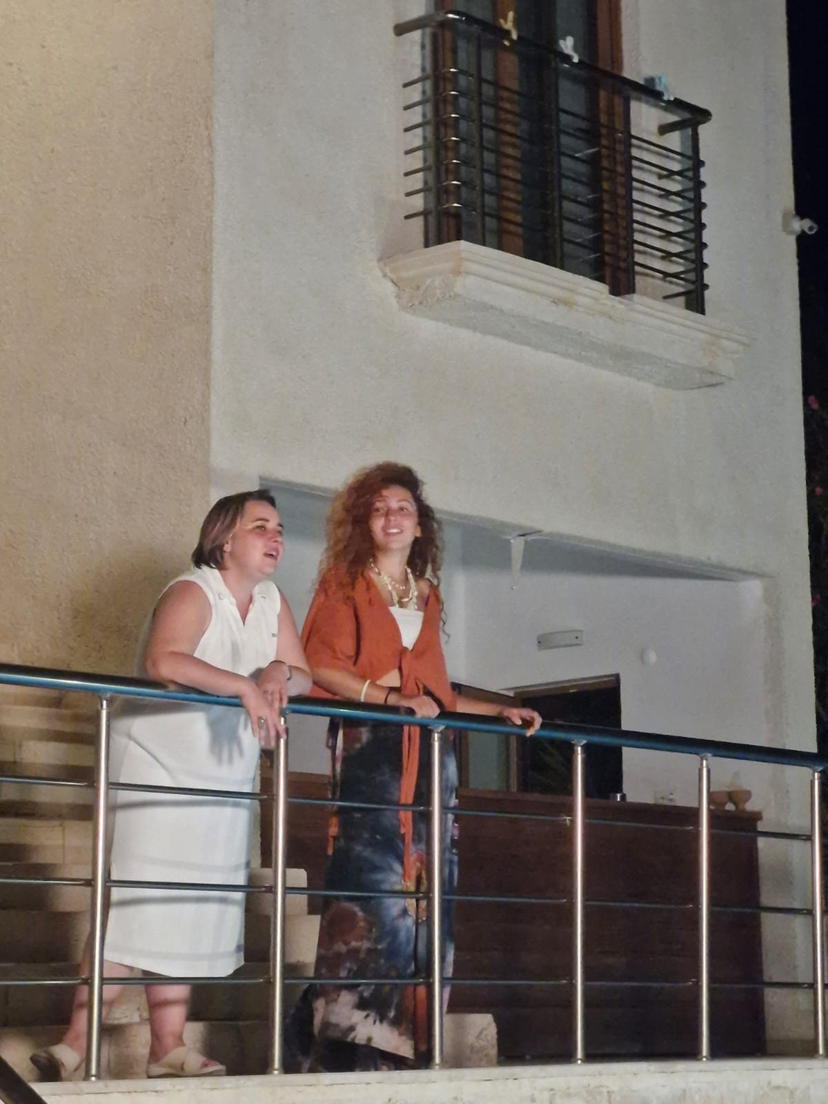 Two actors on a balcony during the shoot